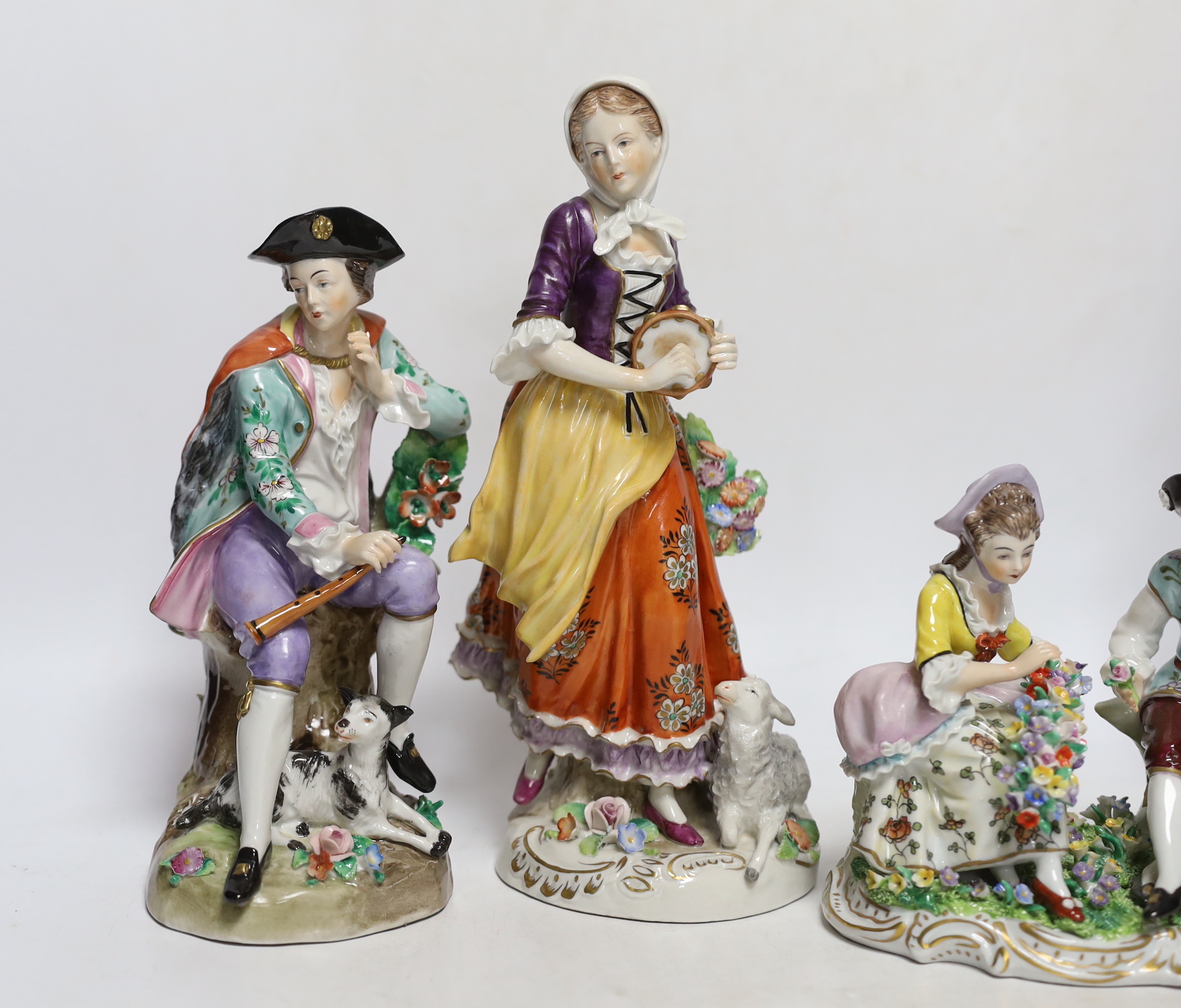 Four Sitzendorf porcelain figures in groups, early 20th century, 26cm